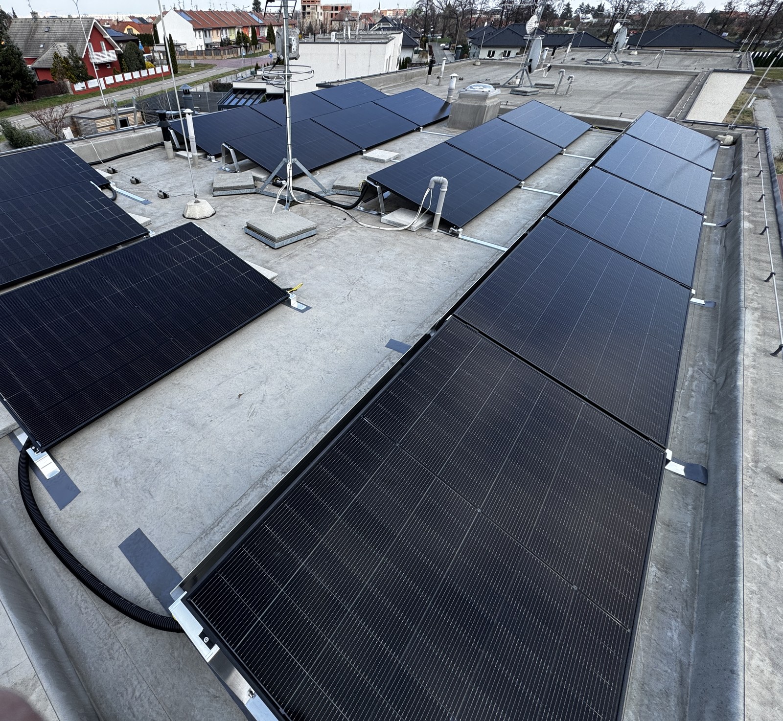 Aerial view of solar panels installed on the flat roof of a commercial building