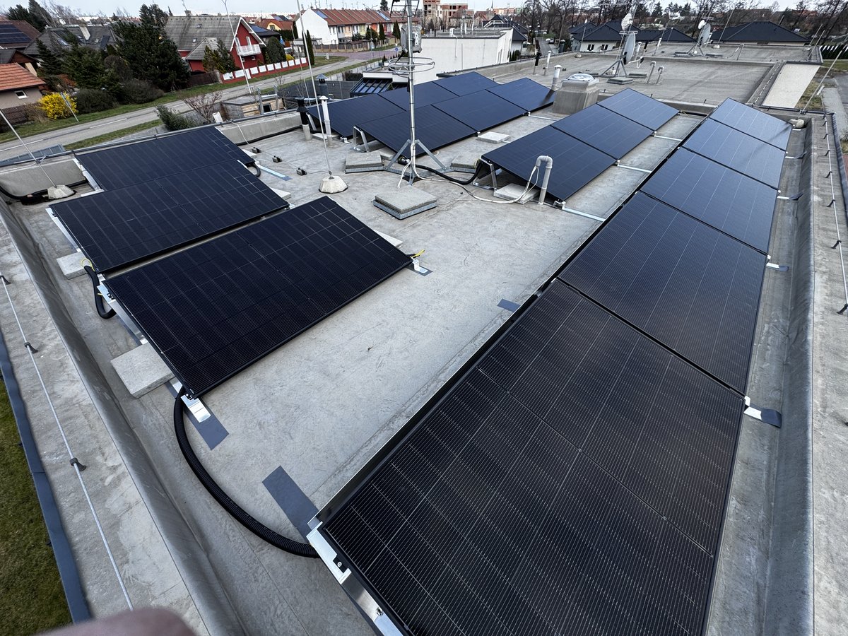 Aerial view of solar panels installed on the flat roof of a commercial building